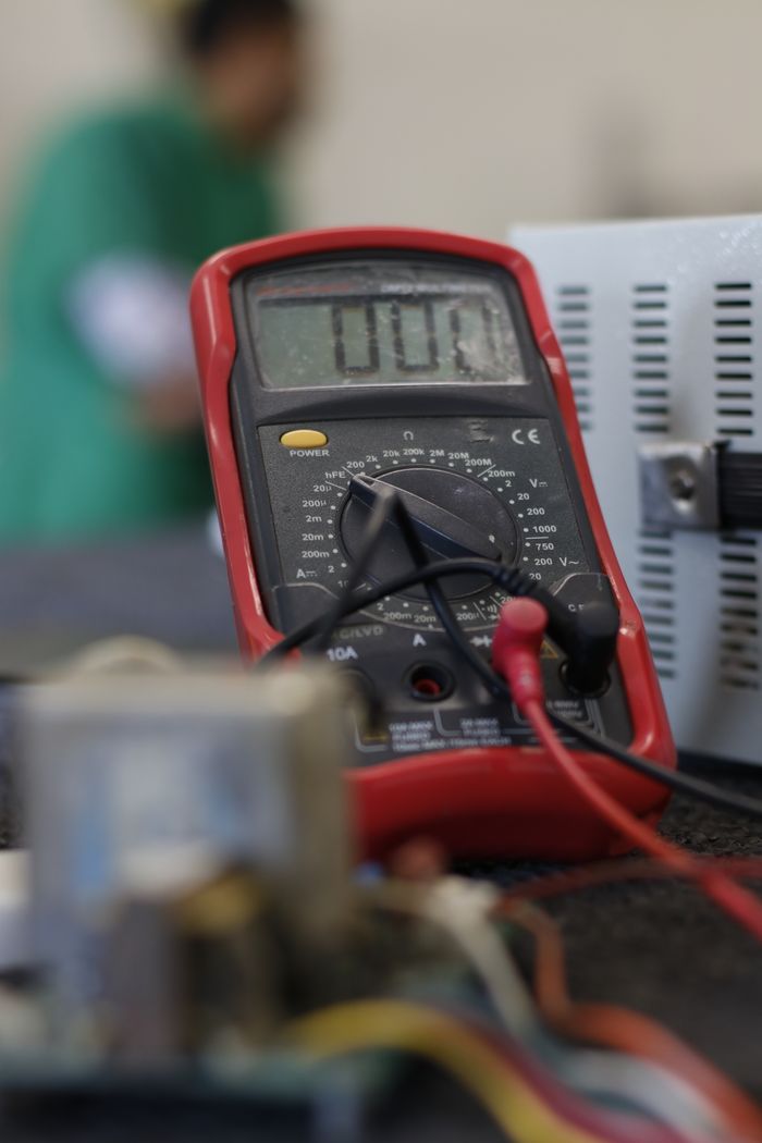 gallery-6 Close-up shot of a multimeter used for electrical measurements, with focus on the display.