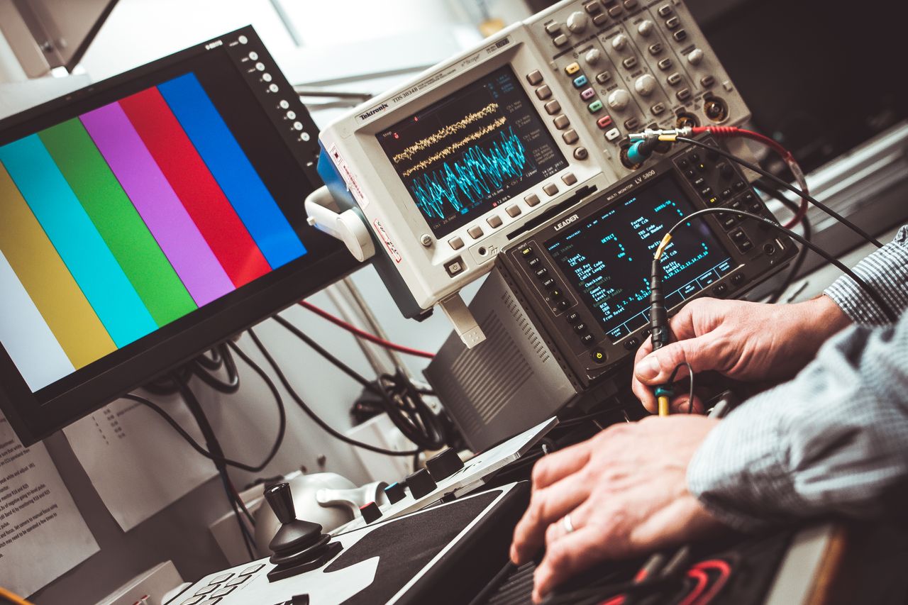 gallery-2 Technician operating laboratory electronic testing and measurement devices with colorful display.