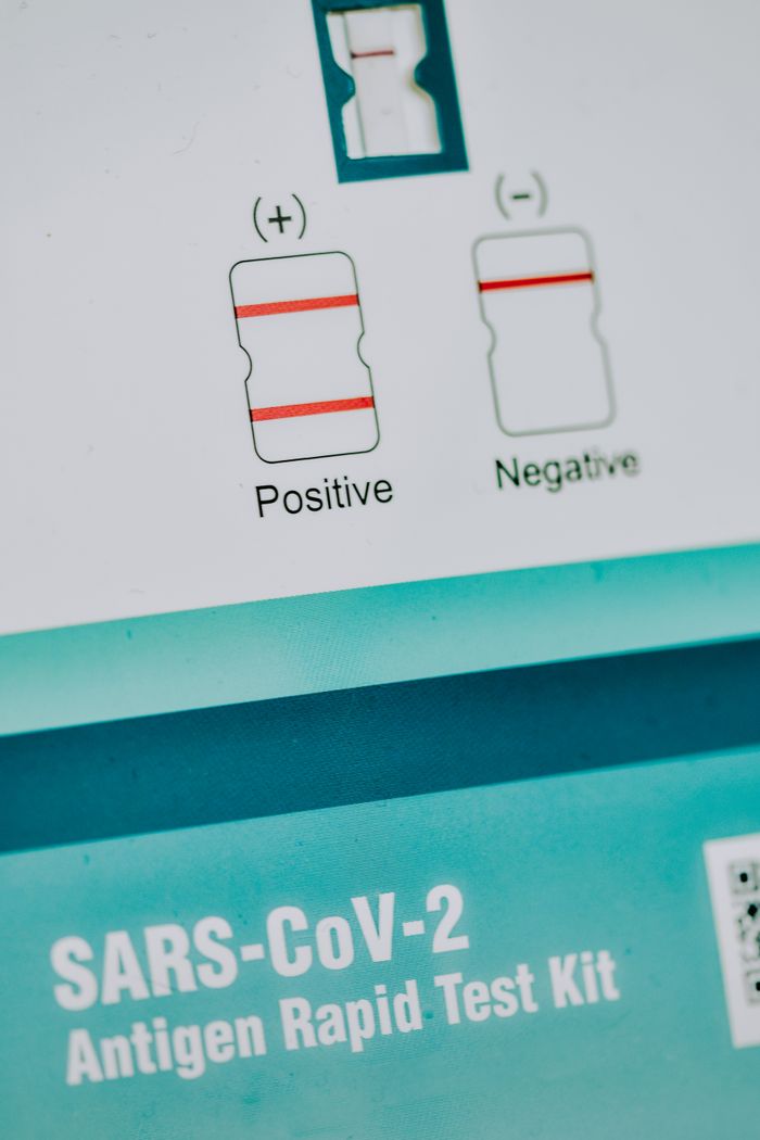gallery-3 Detailed view of a SARS-CoV-2 antigen rapid test kit with result indicators.